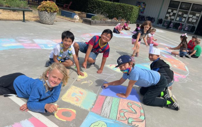 Students create sidewalk art in chalk